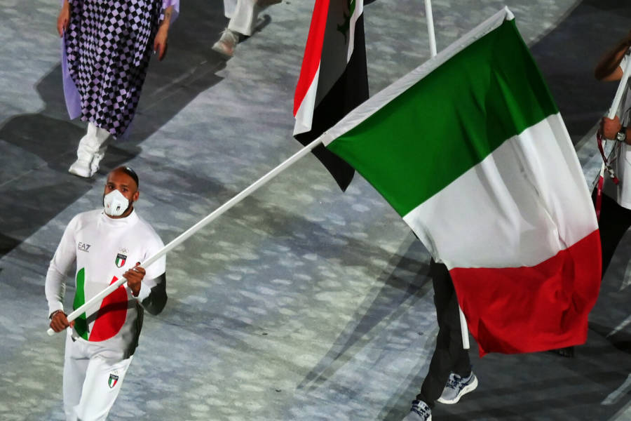 Italy's Marcel Jacob carries his national flag during a closing ceremony of the Tokyo 2020 Olympic