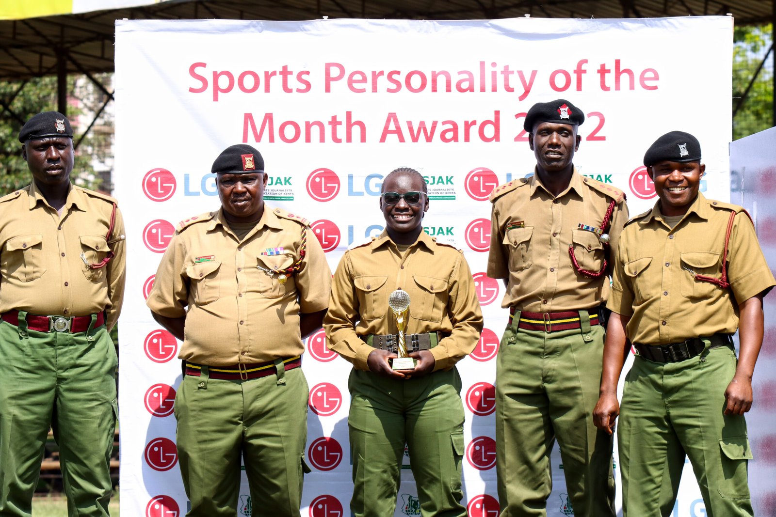 Kenya Lionesses star Grace Adhiambo centre poses with officers from the National Police College in Embakasi scaled