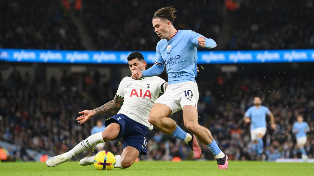 Romero tackles Jack Grealish.