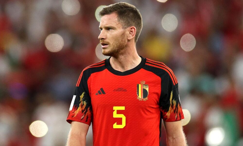  Jan Vertonghen is playing soccer for Belgium while wearing a red jersey with the number 5 and looking to the left.