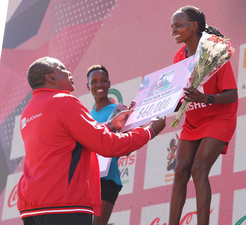 Agnes Barsosio with a dummy cheque after winning the Nairobi City Marathon. PHOTO/Courtesy