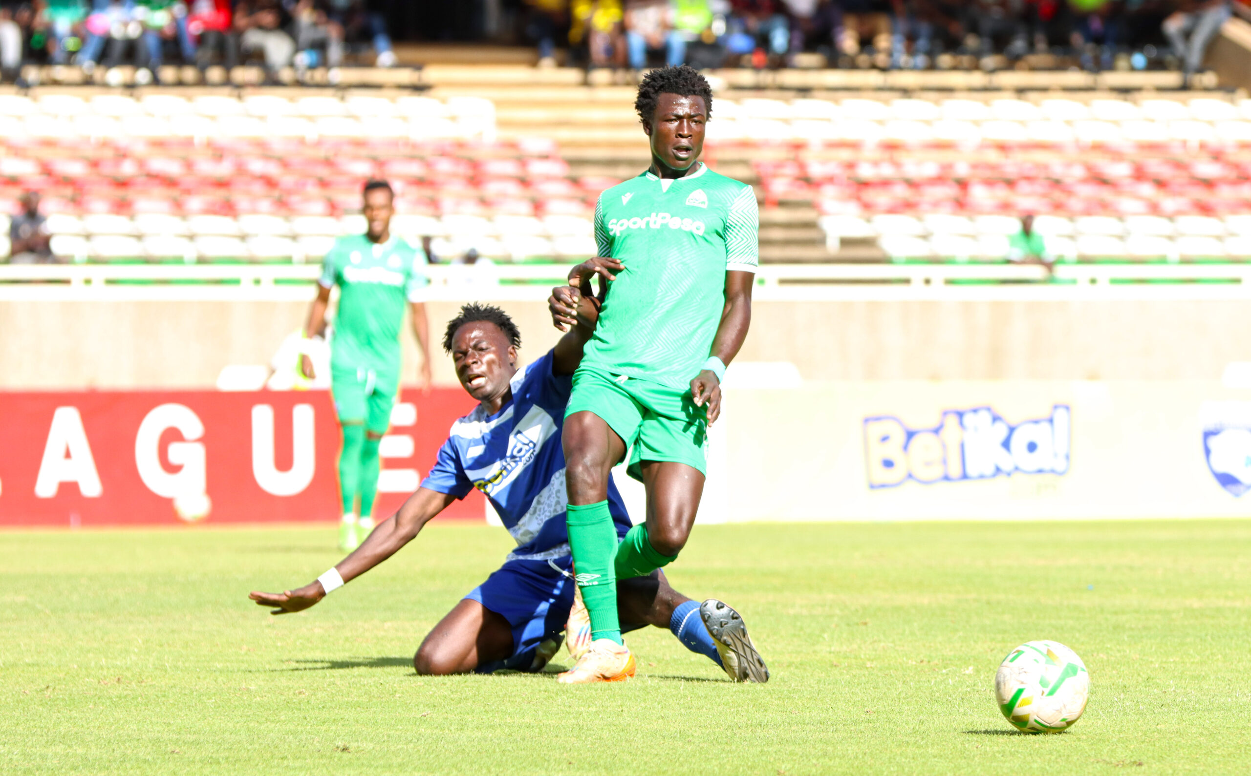 Kevin Juma of Gor Mahia passes the ball under pressure from Robert Kweyu of AFC Leopards 