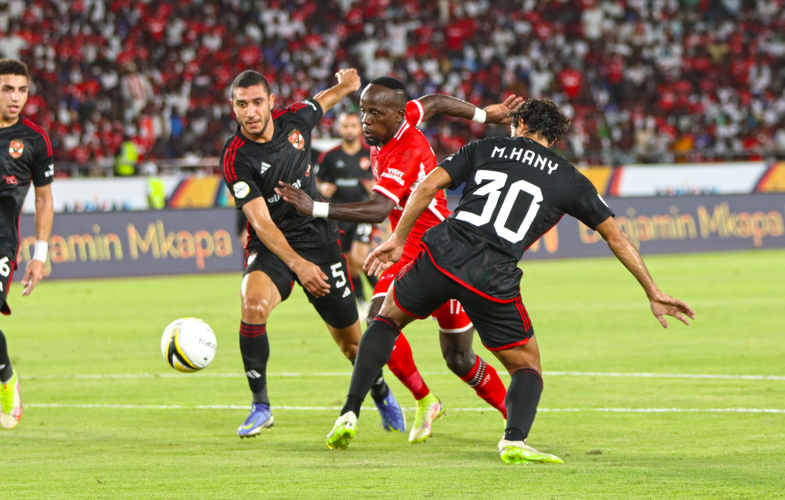 Simba's Clatous Chama attempts to find a way past Al Ahly defenders