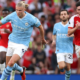 Haaland battles the ball with Arsenal's Declan Rice