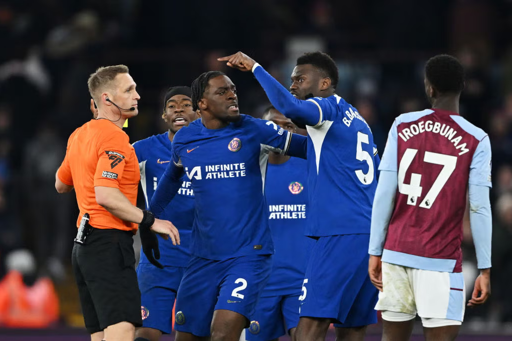 Chelsea players with the referee after their late goal was ruled out.