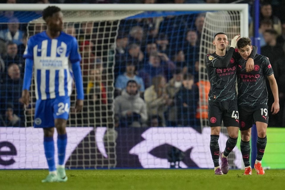 Phil Foden celebrates with Julian Alvarez