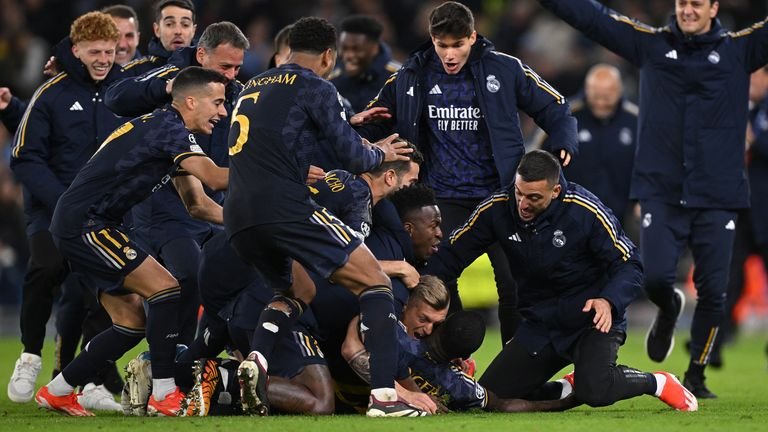 Real Madrid players celebrate winning against Manchester City in penalties